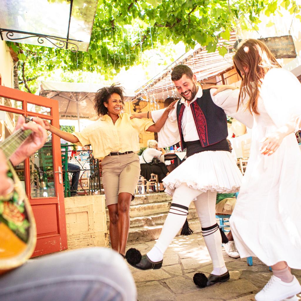 Travelers dancing with a local host during a traditional cultural experience on a Trafalgar tour.