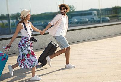 A couple runs with luggage