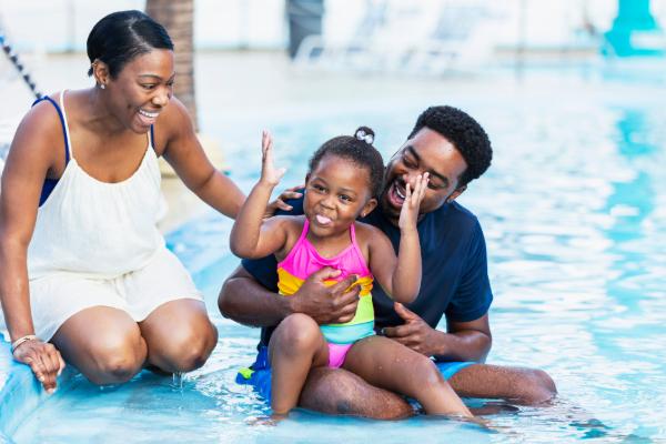 Family enjoying a warm-weather waterpark getaway during a school break.