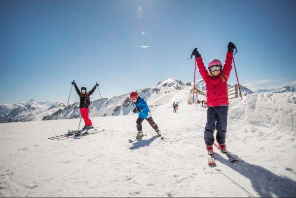 Children enjoying a family ski vacation during midwinter break.