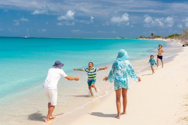 Family enjoying a tropical beach getaway during a school break.