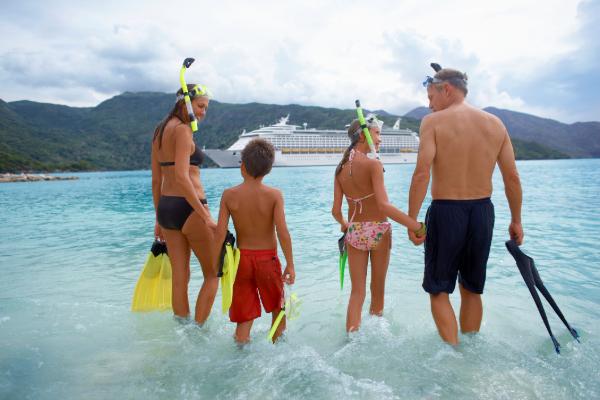 Family preparing to snorkel during a cruise vacation in the Caribbean.