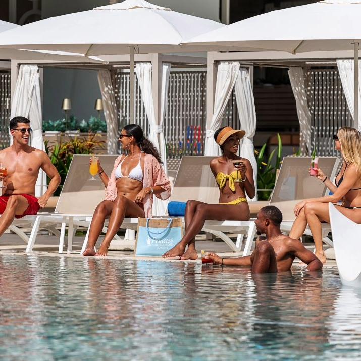 Friends sharing drinks and relaxing poolside at Princess Hotels & Resorts Jamaica