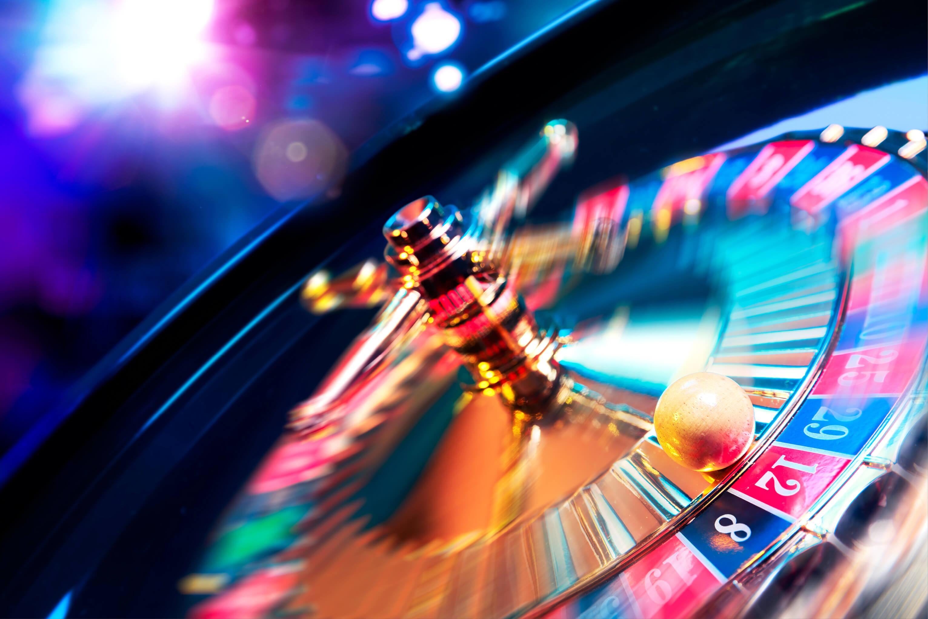 A roulette wheel in a casino, featuring a white ball positioned on the spinning numbers