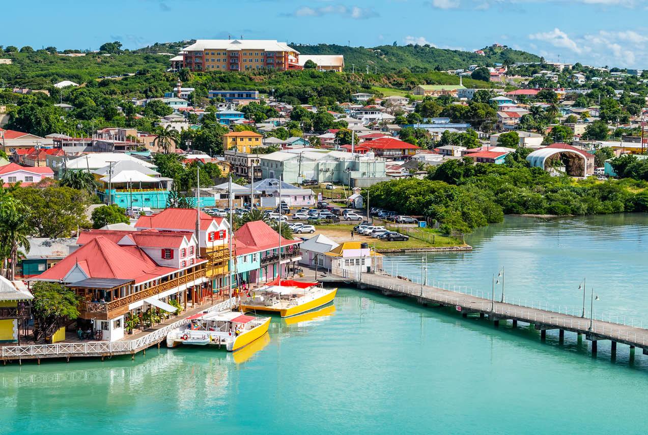 Aerial view of colorful seaside town and turquoise waters in Antigua