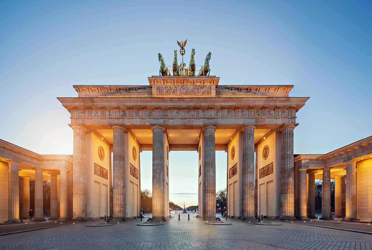 The Brandenburg Gate in Berlin, Germany, a historic neoclassical monument, stands tall against a clear blue sky