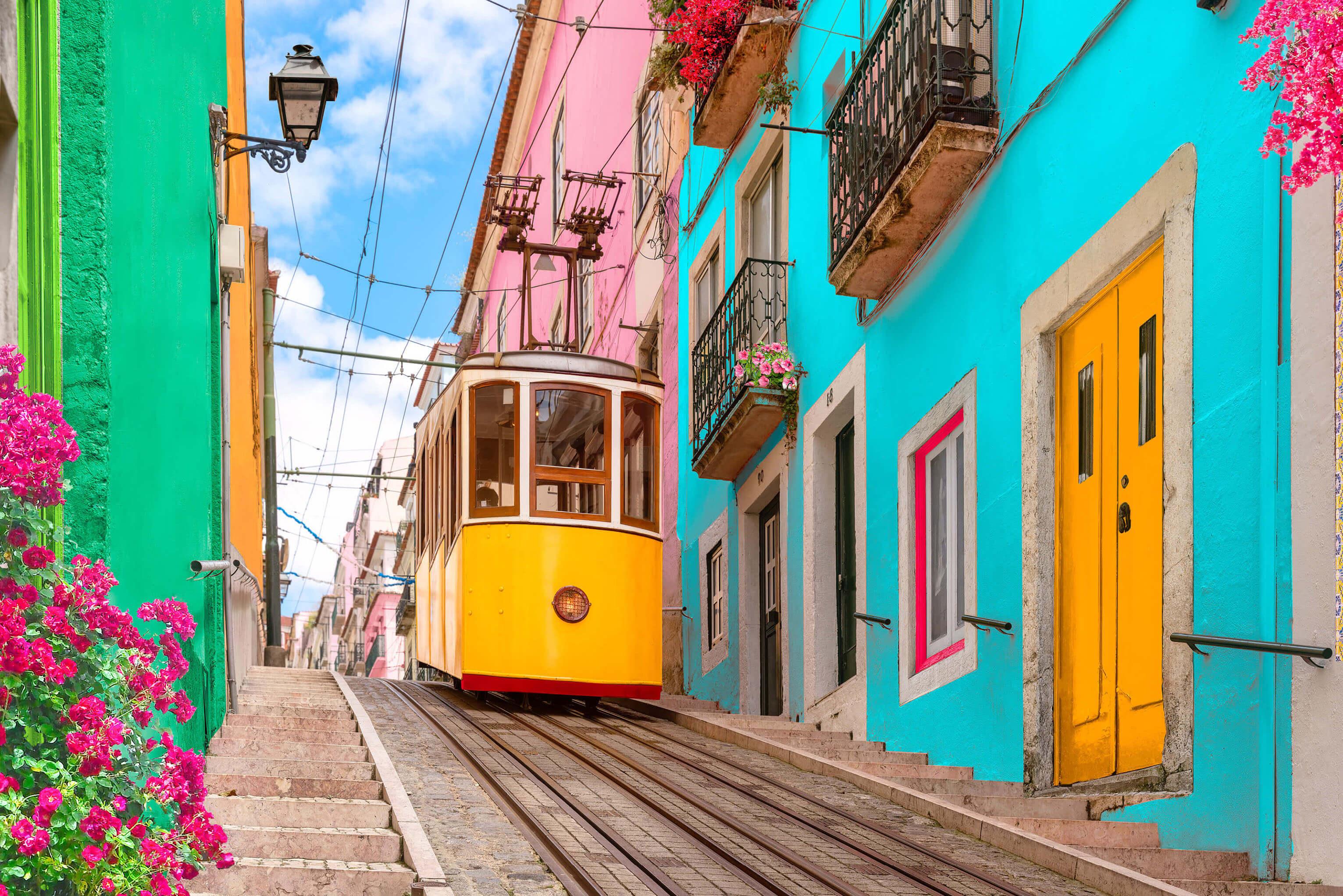 A tram gliding down the road surrounded by charming architecture in Lisbon, Portugal