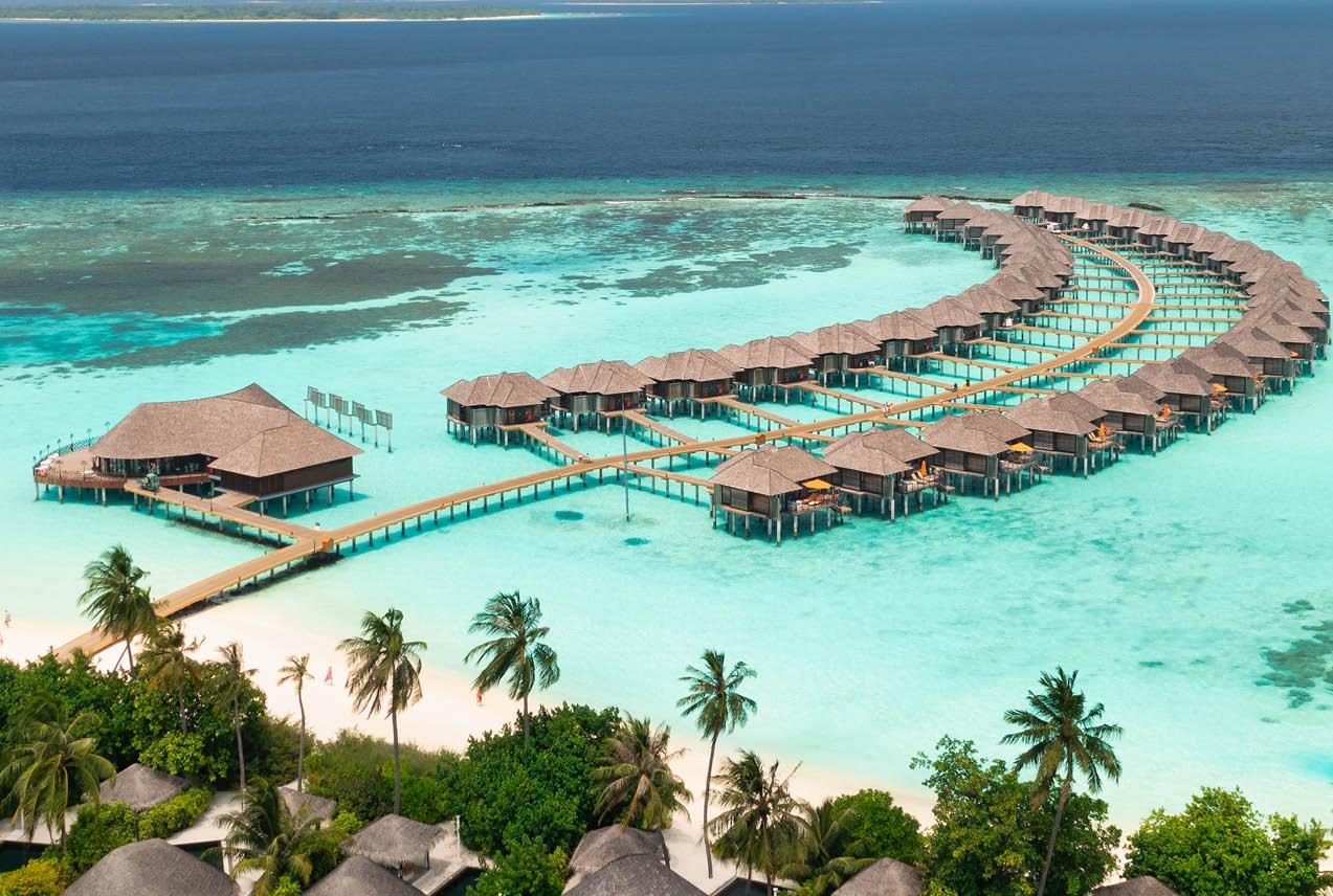 Maldives resort featuring overwater bungalows and vibrant azure ocean