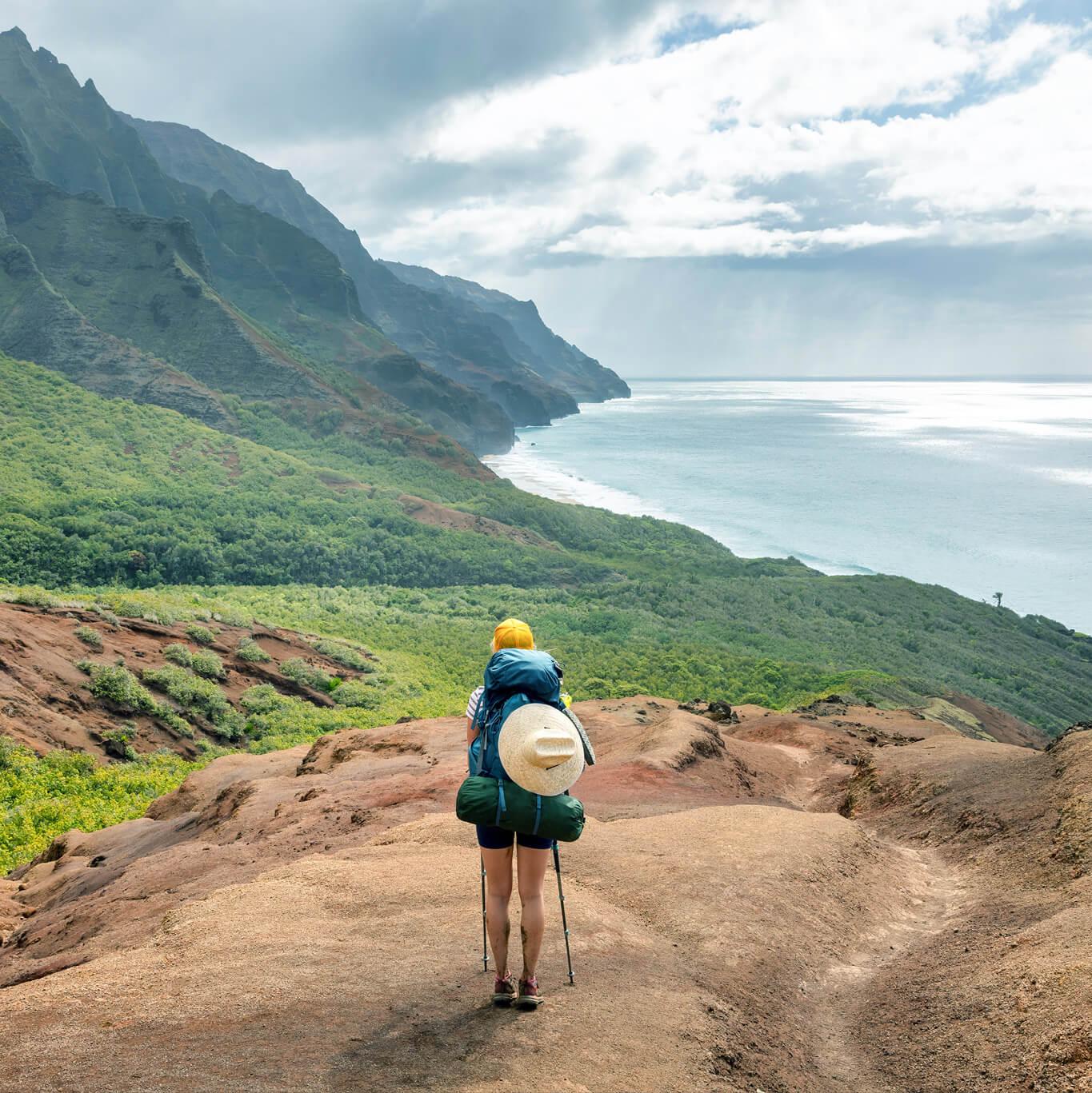 A hiker overlooks a scenic view in Kauai, Hawaii