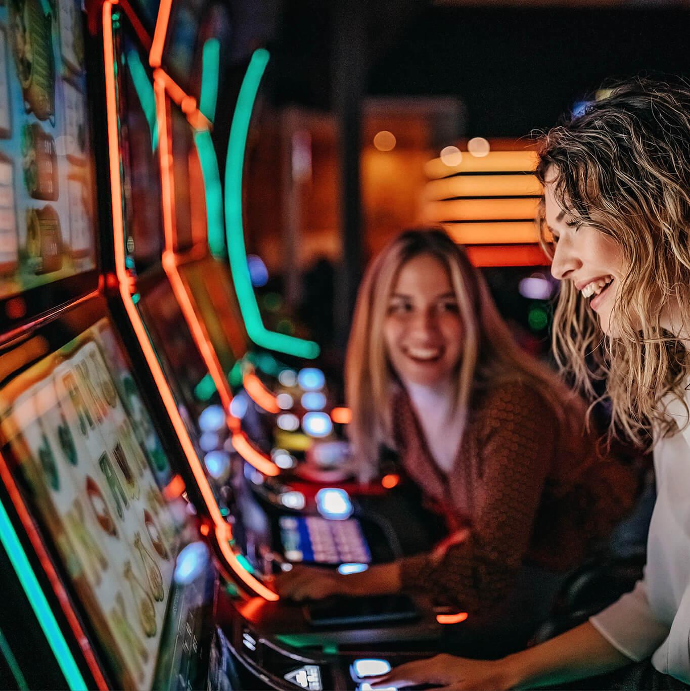 Two women play the slot machines in Las Vegas