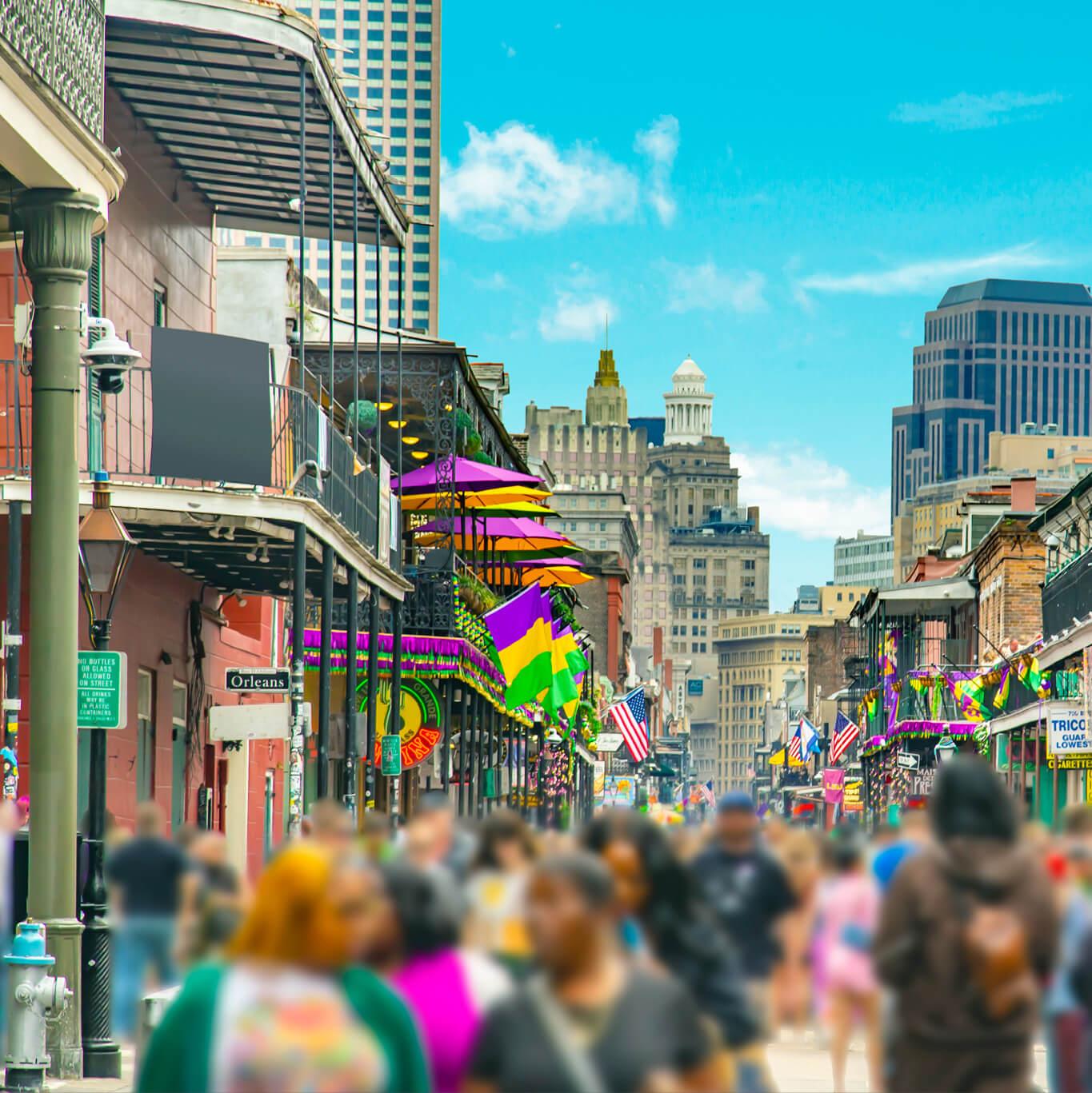 A crowd strolls along Bourbon Street in New Orleans