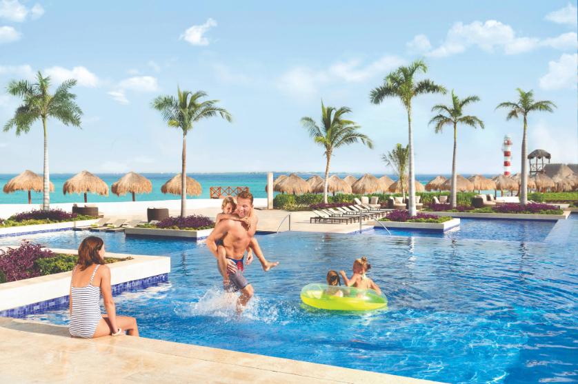 Family enjoying a sun-soaked pool at an all-inclusive Playa Hotels & Resorts beach resort