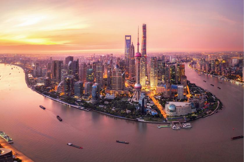 Aerial view of Shanghai's modern skyline and waterfront at sunset