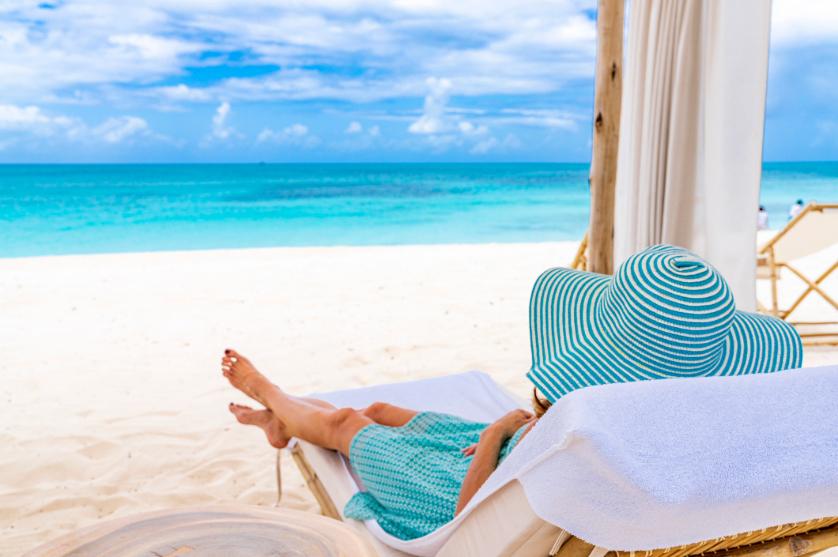 Traveler relaxing on a Caribbean beach during a tropical cruise vacation