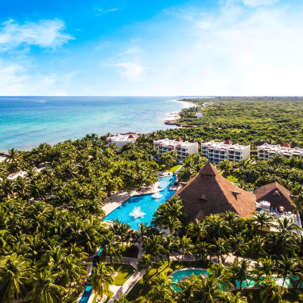 Aerial view of a Lomas Hospitality beachfront resort surrounded by tropical gardens along the Riviera Maya coastline.