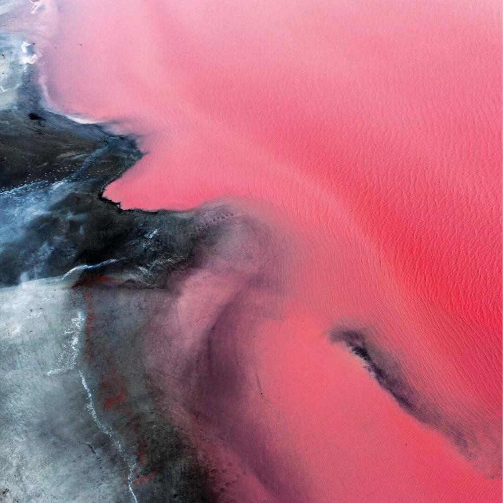 Aerial view of a vibrant pink lake featured on a Captain’s Choice journey.