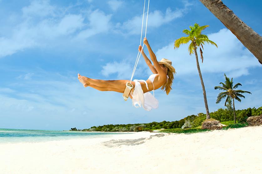 woman on a swing at the beach