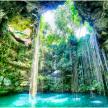 A serene cenote in Mexico, soft light slicing through an opening overhead
